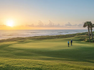 Early morning golfers on Jacksonville Beach Golf Course with ocean in background